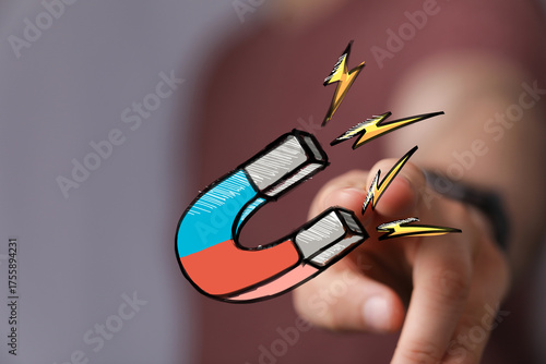 Hand pointing at a magnet, ...
