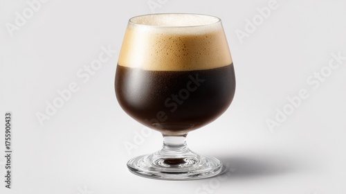 Dark stout beer with thick creamy foam head in elegant snifter glass on white background, rich black beverage alcoholic drink craft brewery product