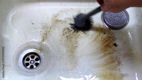 A man cleans spoiled red wine in the sink with chlorine bleach time lapse