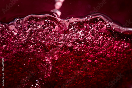 Foto Macro shot of red wine in motion.