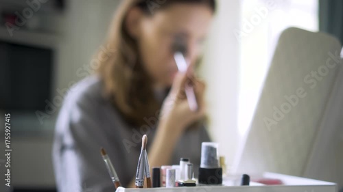 Close-up photo of a teenage girl applying foundation and powder. Young, stylish girl showcasing self-care and beauty in her personal makeup routine.