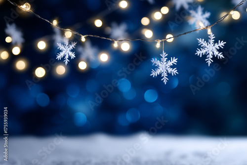 Decorative winter lights and snowflakes hanging against blue backdrop