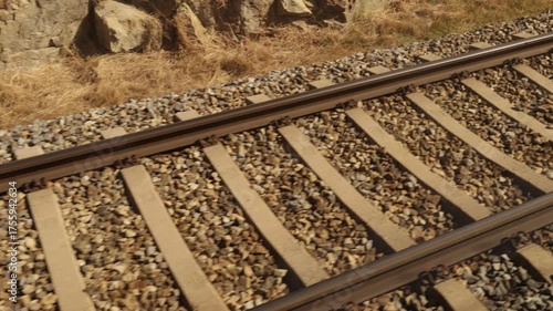Train moving along railway tracks with motion blur, symbolizing speed, travel, and transportation.