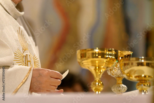 Holy Host in the hands of a priest during the celebration of Holy Mass in a Catholic church