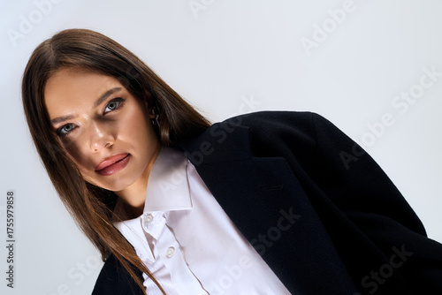 Wallpaper Mural Stylish young woman showcases autumn fashion in elegant grey studio setting Torontodigital.ca