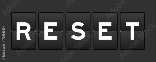 Black color analog flip board with word reset on gray background