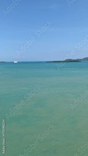 Blue sea and bright blue sky, vertical