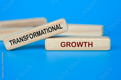 Wooden blocks showing TRANSFORMATIONAL GROWTH text for innovation and change.