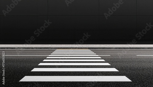 Empty street with zebra crossing against a dark wall. Template or mockup with space for text. Black backdrop.