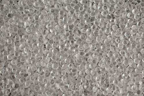 Texture of virgin polystyrene granules, close-up. Granulated plastic polymer. PS granules, transparent beads. Virgin GPPS pellets