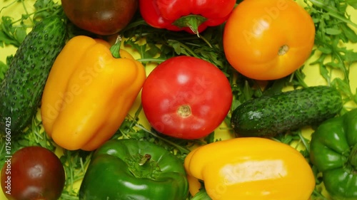 Set of various vegetables flat lay, 360 degrees rotation. Tomato, pepper and cucumber on yellow background, top view. Vegetarian and healthy food