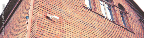 Security camera on the wall of a brick building