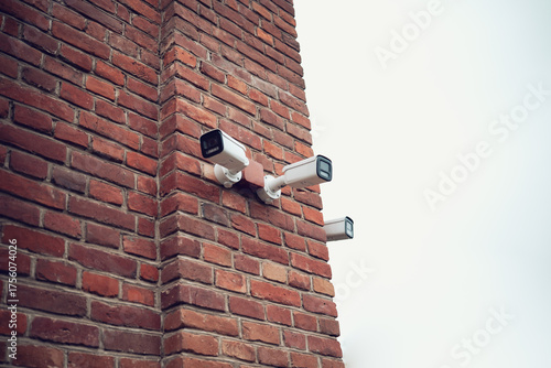 Security camera on the wall of a brick building