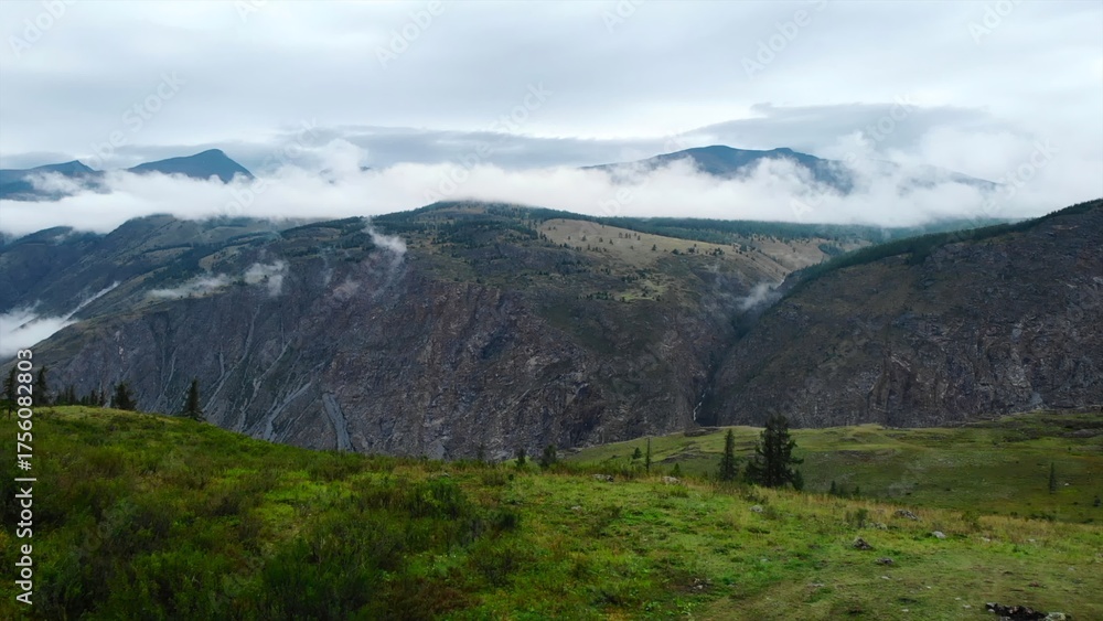 Obraz premium Clouds gently flowing over the kurai steppe and the north chuya ridge. Media