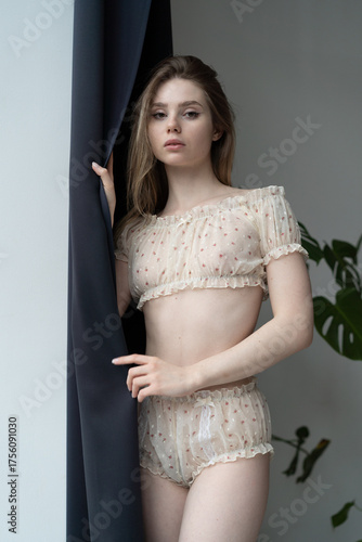 Young beautiful woman posing in white lingerie 