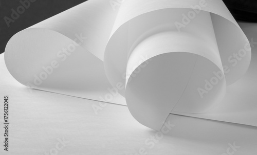 A roll of white paper in black and white.