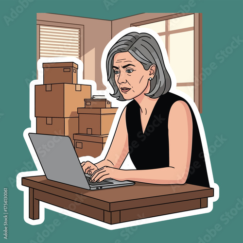 Woman working on laptop surrounded by moving boxes