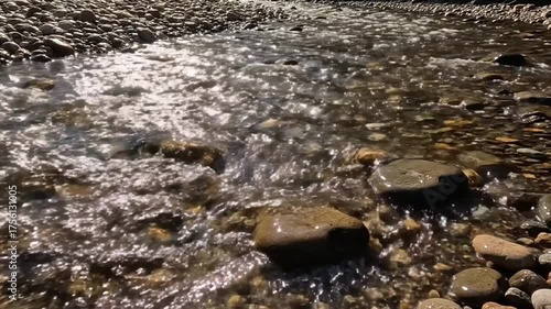 Clear flowing water over stones natural light landscape