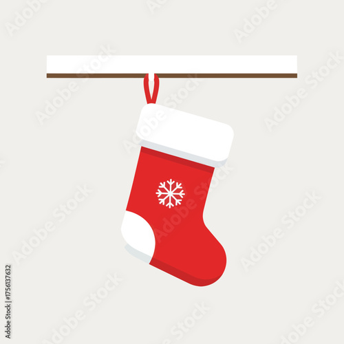 Red Christmas stocking with a snowflake hanging on a mantelpiece.