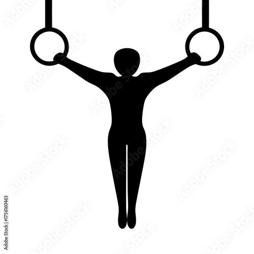 Silhouette of gymnast on gymnastic rings performing a strength exercise maneuver
