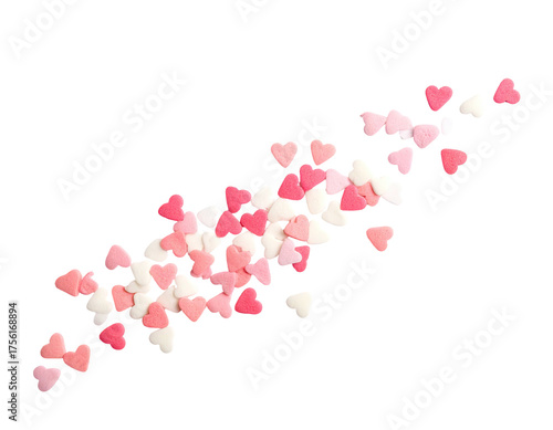 A collection of small, pink, and white heart-shaped candies scattered on a stark black background