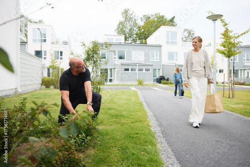 Wallpaper Mural Male gardener greeting resident walking on footpath Torontodigital.ca