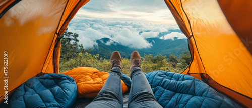 Views of clouds and mountains from the tent, feet in warm sleeping bags - for travelling, camping and inspiring adventure.