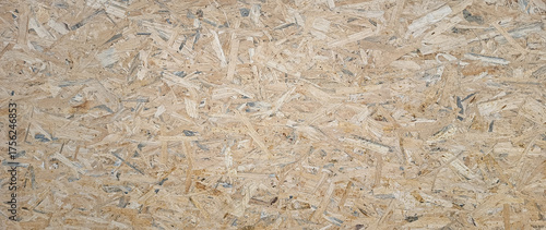 Photos OSB boards made of brown wood chips sanded into wooden background