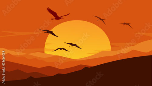 Birds flying over mountains at sunset sky