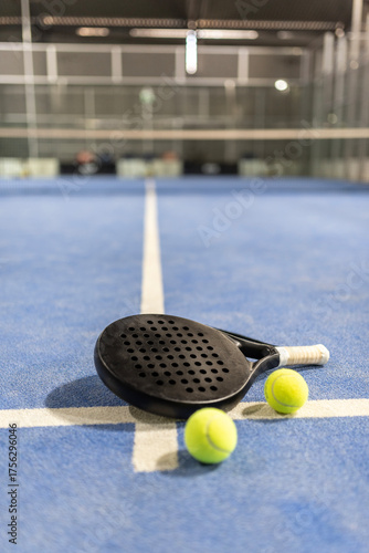 Paddle tennis racket nd balls in court