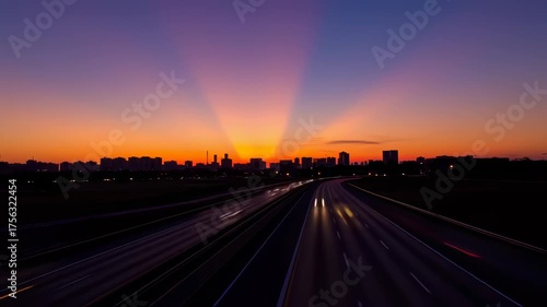 Sunset Highway Cityscape: Dynamic Traffic Trails and Vibrant Sky