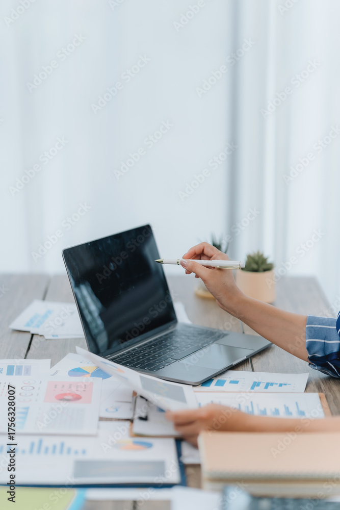 Fototapeta premium Businesswoman Analyzing Financial Data on Laptop