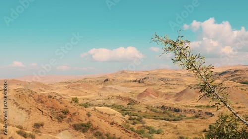 Winding clay paths and vibrant red hills captured in dry Georgian savannah, showing the raw power of erosion and silence in nature-themed stock imagery. Pan shot.