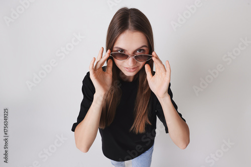 Woman wearing black t-shirt and sunglasses on white background, above view. Mockup for design