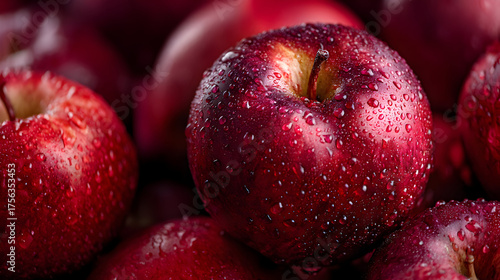 Red apple texture glistens with droplets. Macro surface detail creates bold, juicy aesthetic for product staging, fruit branding, or vibrant poster design.