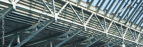 Modern steel and glass architecture with geometric framework and structural beams.
