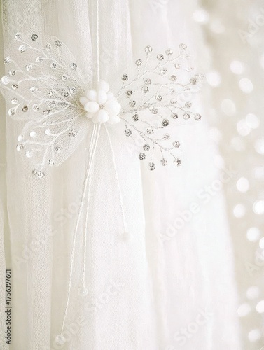 Delicate white fabric features a stunning butterfly design adorned with sparkling beads, enhancing the elegant setting