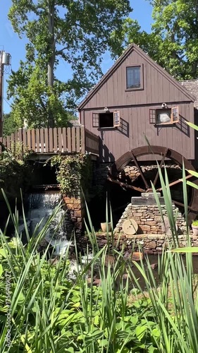 Historic Watermill by Lush Greenery in Summer
