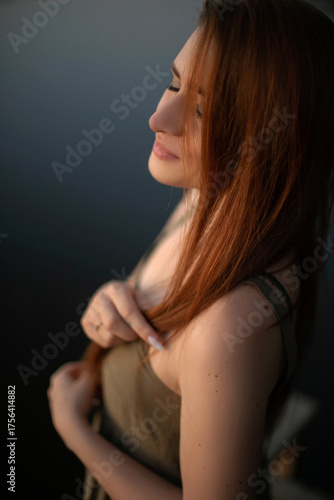 Serene Woman with Red Hair in Golden Hour Light