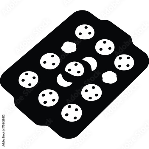 A black baking sheet with circular indents and some moon and flower shaped indents on a white background silhouette