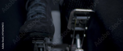 Close-up video of a race car drivers legs and feet engaging the pedals
