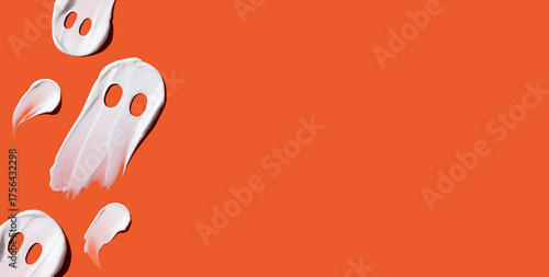 Halloween concept, ghosts in the form of cosmetic smears on an orange background. Skin moisturizing in autumn. Ghost concept
