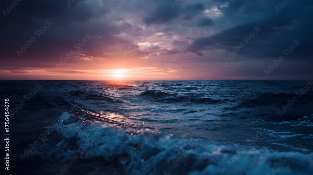 Fototapeta premium Dramatic sunset over a dark undulating ocean with atmospheric clouds