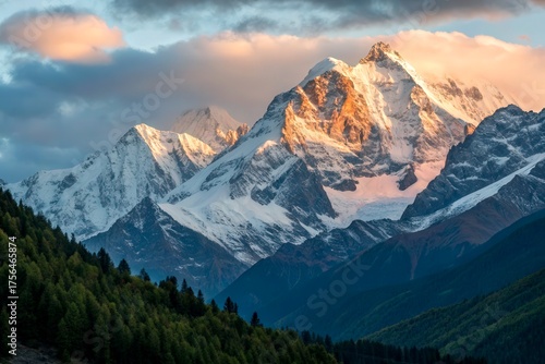 Majestic Snow-Capped Peaks Under Dramatic Sky at Dusk