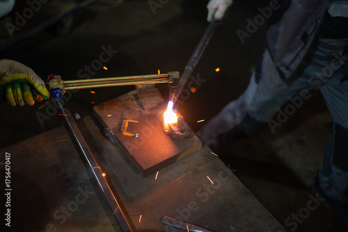 Workers of the blacksmith's workshop heat the metal part to red, for further forging and giving the desired shape. High quality photo