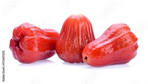 Three vibrant, glossy rose apples in a group, displayed against a clean white background