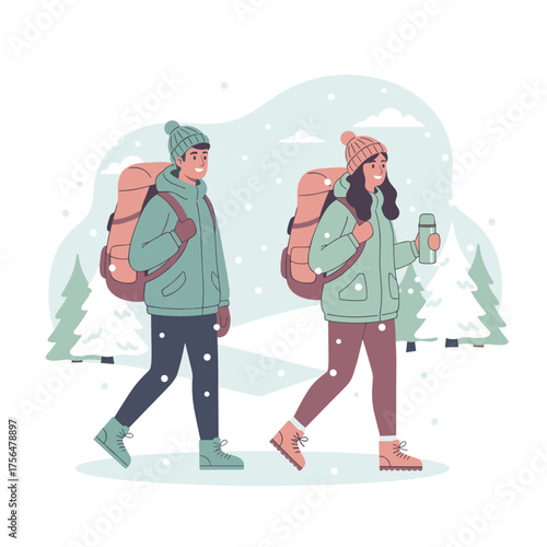 Couple hiking in winter outfits with backpacks enjoying snowy landscape together