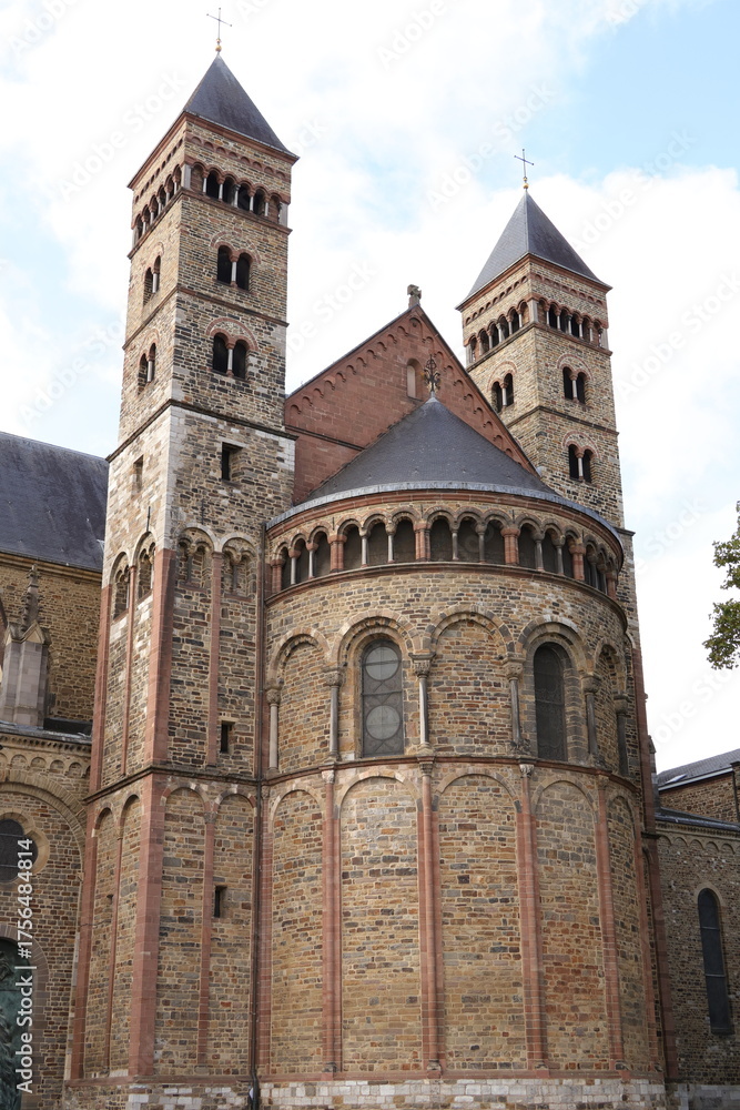 Fototapeta premium Maastricht Church With Twin Towers And Rounded Apse In Autumn Light, Historic Stone Architecture