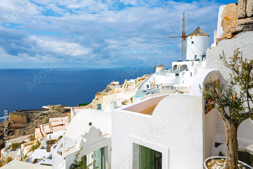 Canvastavla The windmills of Oia, Greece overlook the whitewashed town and blue Aegean Sea on the island of Santorini, Greece