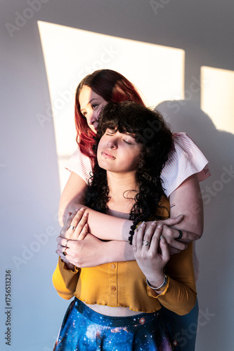 Tender friends embracing with genuine affection